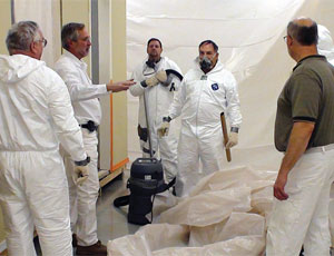 Union painters practice new lead-paint-abatement protection techniques.