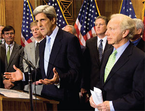 “We’re closer than ever,” says Sen. John Kerry (at podium) with Sen. Joe Lieberman (right).