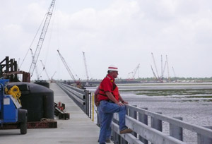 Vic Zillmer, USACE resident project manager atop the surge barrier stretching away toward its land tie-in to Chalmette levees.