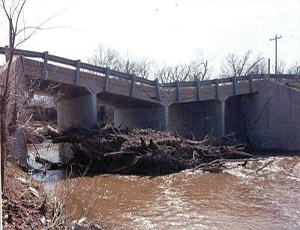 More than wear and tear, debris accumulation can accelerate a bridge’s structural undermining.